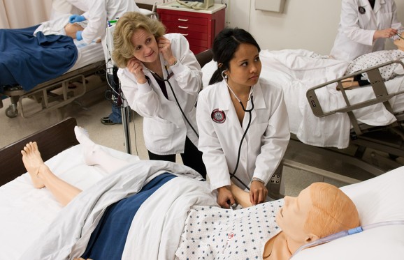 nursing student and instructor examining a practice dummy patient in the Muskingum Nursing Lab
